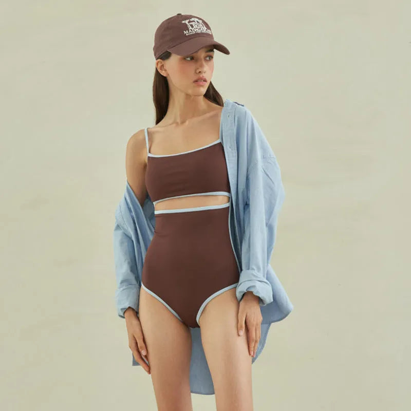 Brown women's one-piece swimsuit with triangle neckline design on mannequin
