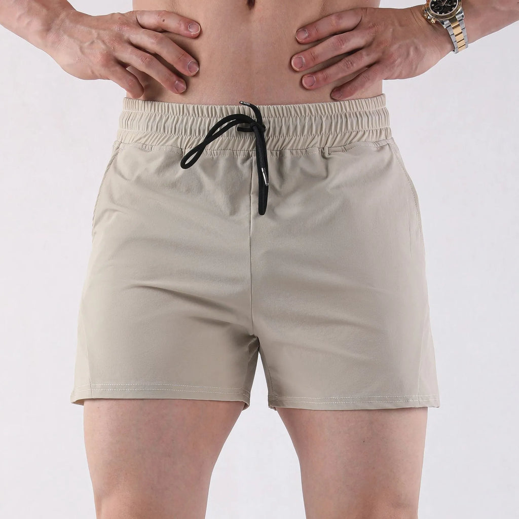 Men's thin grey polyester basketball shorts with an elastic waistband on a plain background.