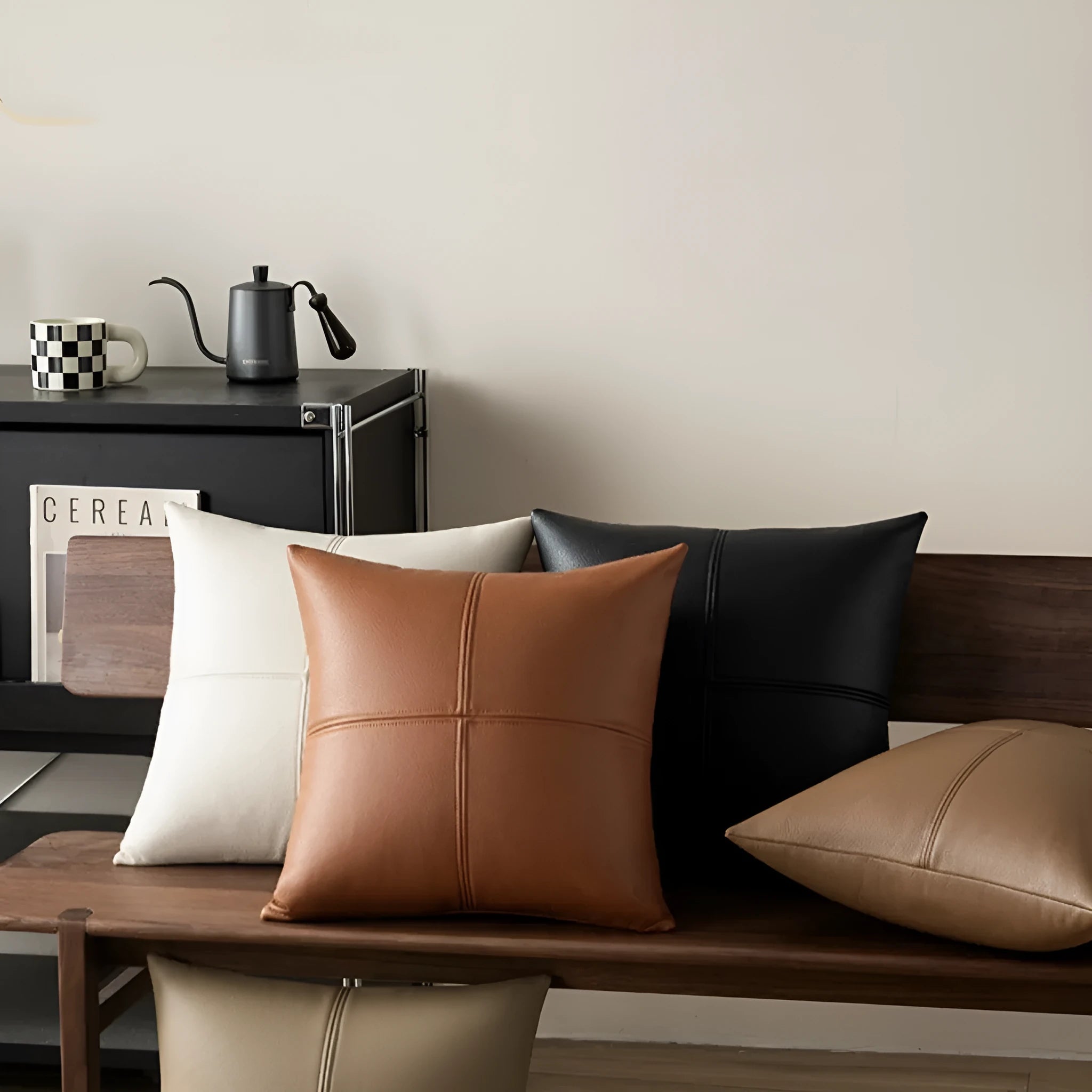 Simple solid colour soft cowhide leather pillow cover on a grey sofa