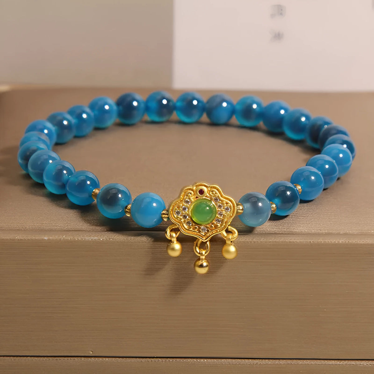 Blue sugar heart agate safety lock pendant on a crystal women's bracelet with alloy inlay and rhinestones.