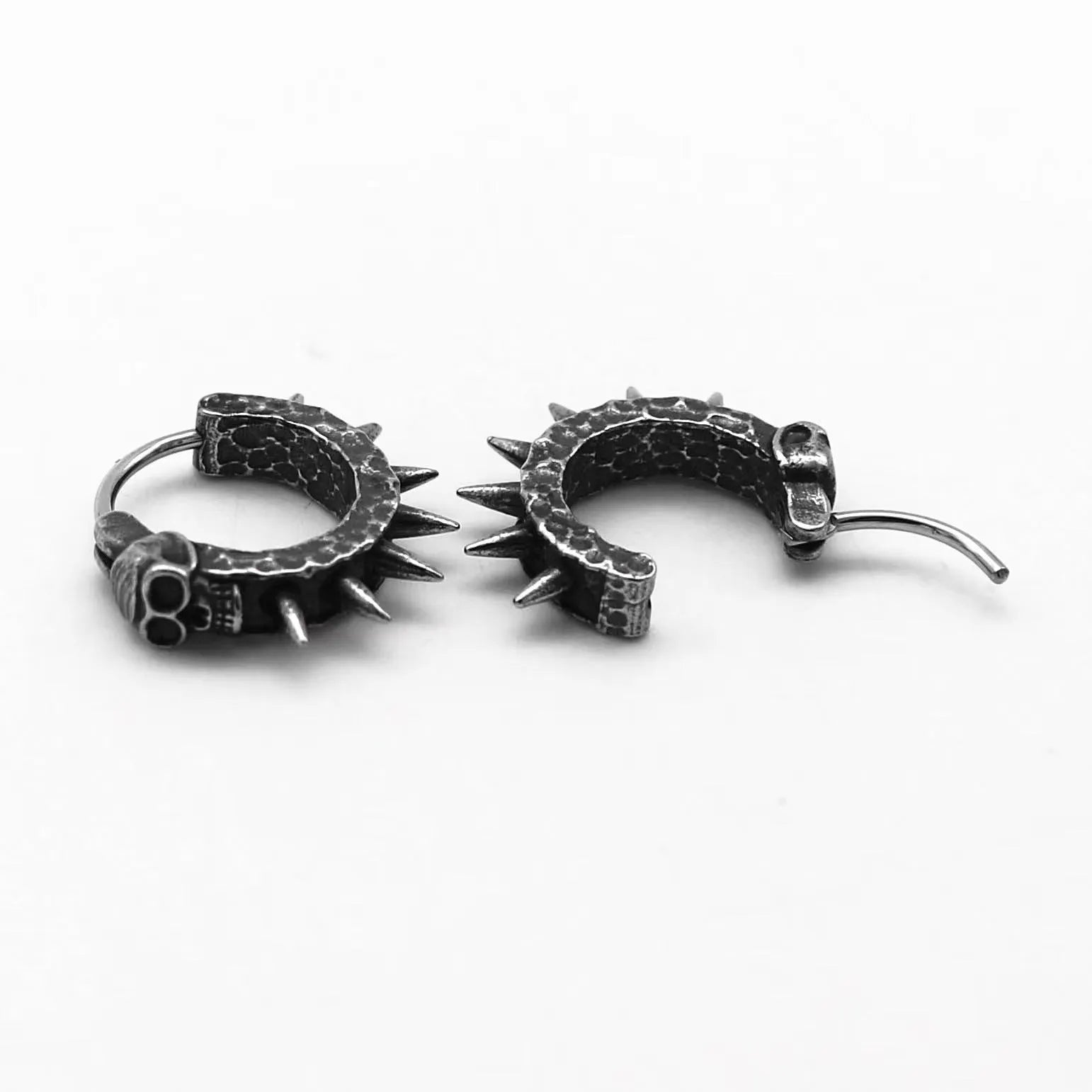 A pair of black alloy punk-style earrings shaped like geometric motorcycles.