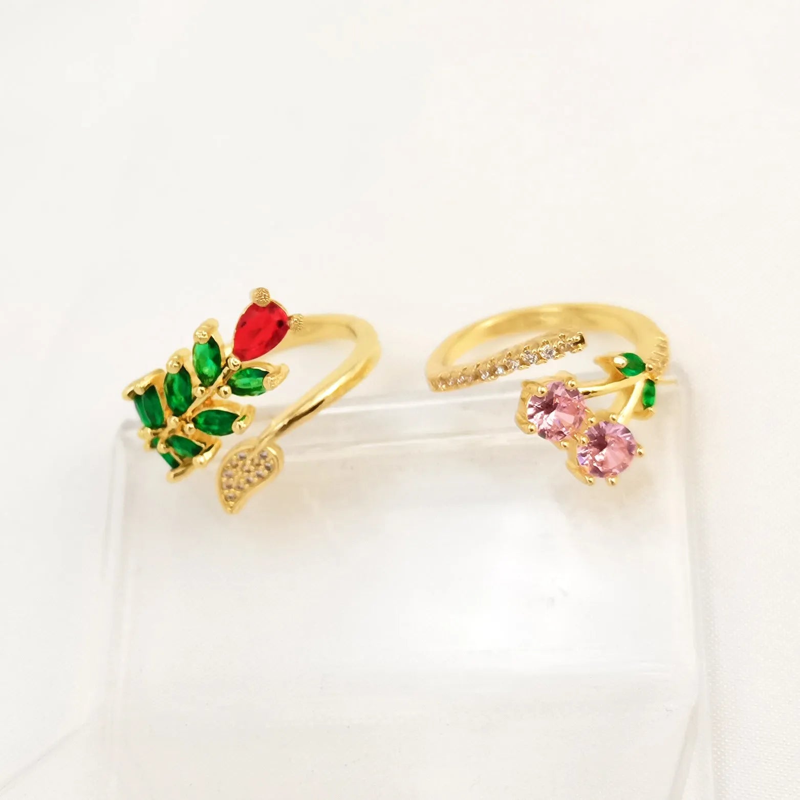 Copper geometric open ring with gold zircon plating and micro-inlaid leaf design, shown in two colours.