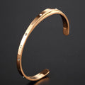 Open-ended stainless steel bracelet with zircon stones in rose gold colour