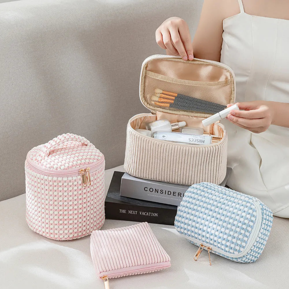 Four cube-style flannelette makeup bags in different colours: pink, khaki, pink dots, and blue with dots