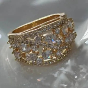 Copper hollow fashion ring for women in a round design, shown in gold and platinum with blue and white stone accents.