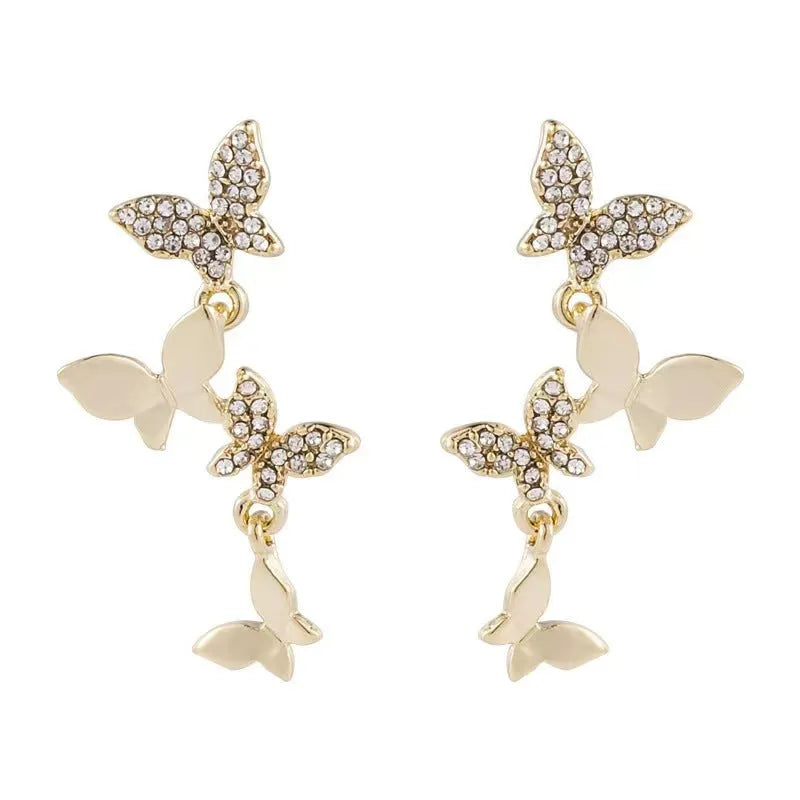 Women's gold-coloured copper earrings with four butterfly design elements in drop style
