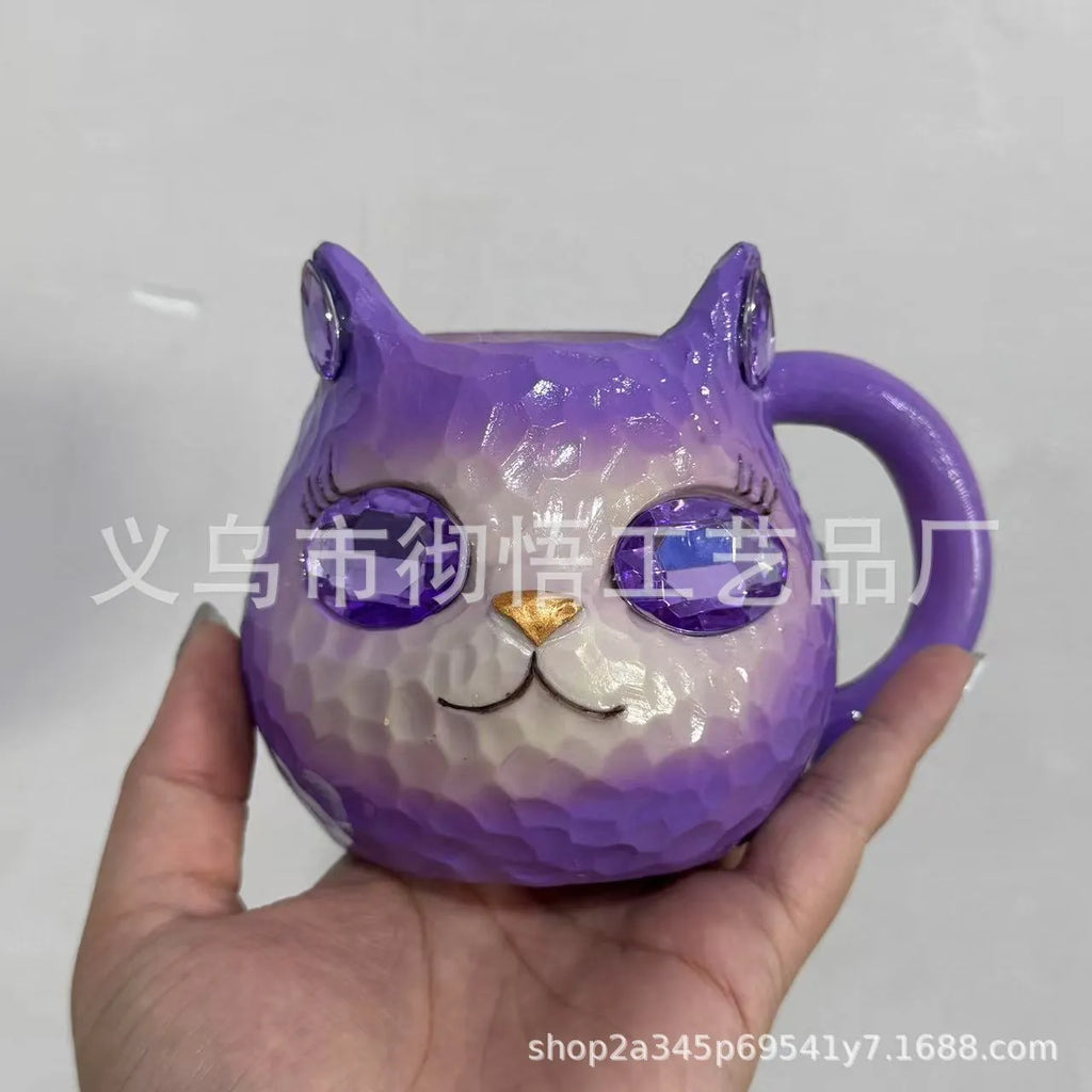 Decorative resin cat cup paperweight in American crafts style, shown in purple, green, blue, and pink colour options.