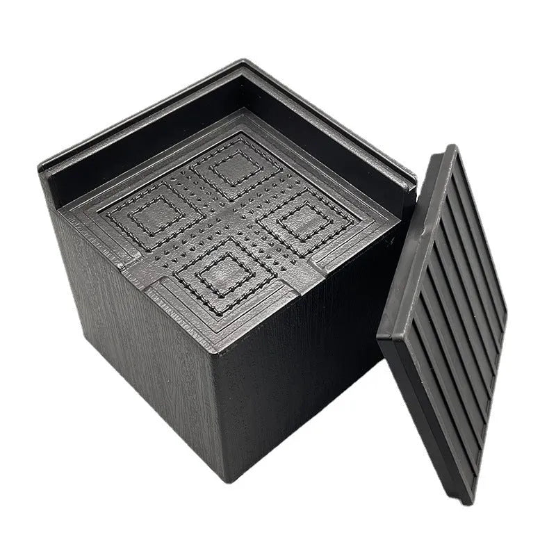 Four black plastic furniture foot mats for sofa and bed height adjustment
