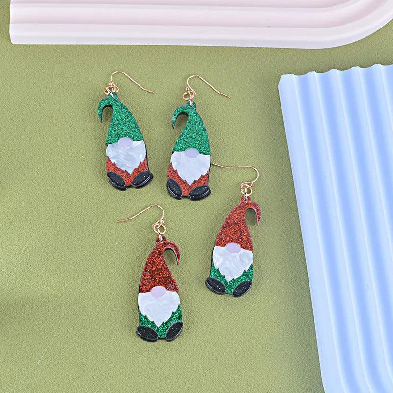 A pair of colourful Santa Claus cartoon character earrings made from acrylic, showing red and green hat style options.