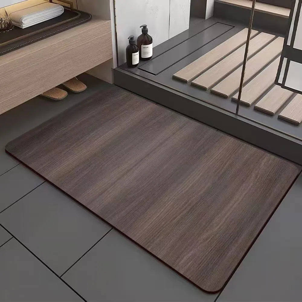 Square diatomite bathroom floor mat with wood grain geometric pattern on a bathroom floor.