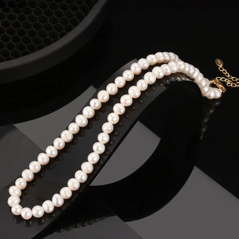 Women's adjustable sterling silver necklace with a single natural freshwater pearl.