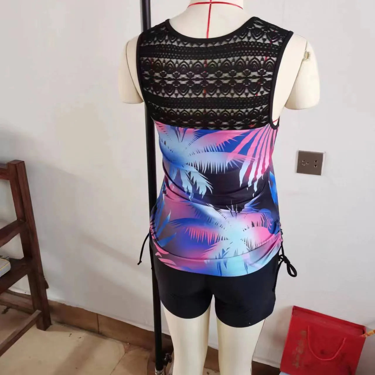 Women's printed lace two-piece swimsuit showing top and shorts in floral pattern