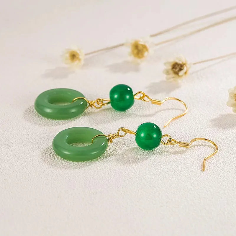 Pair of green jade design earrings with a geometric peace buckle shape on a zinc alloy base with gold plating.