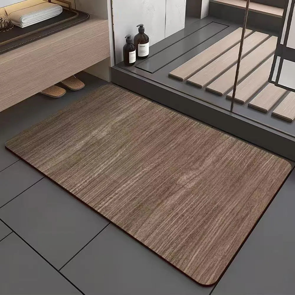 Square diatomite bathroom floor mat with wood grain geometric pattern on a bathroom floor.