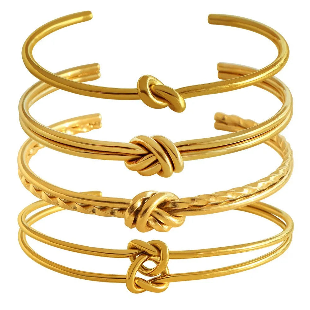 Women's stainless steel C-shaped knotted open bracelet with gold or silver electroplated finish.