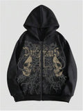 Man wearing a black hooded sweatshirt with a large green skull graphic print on the front.