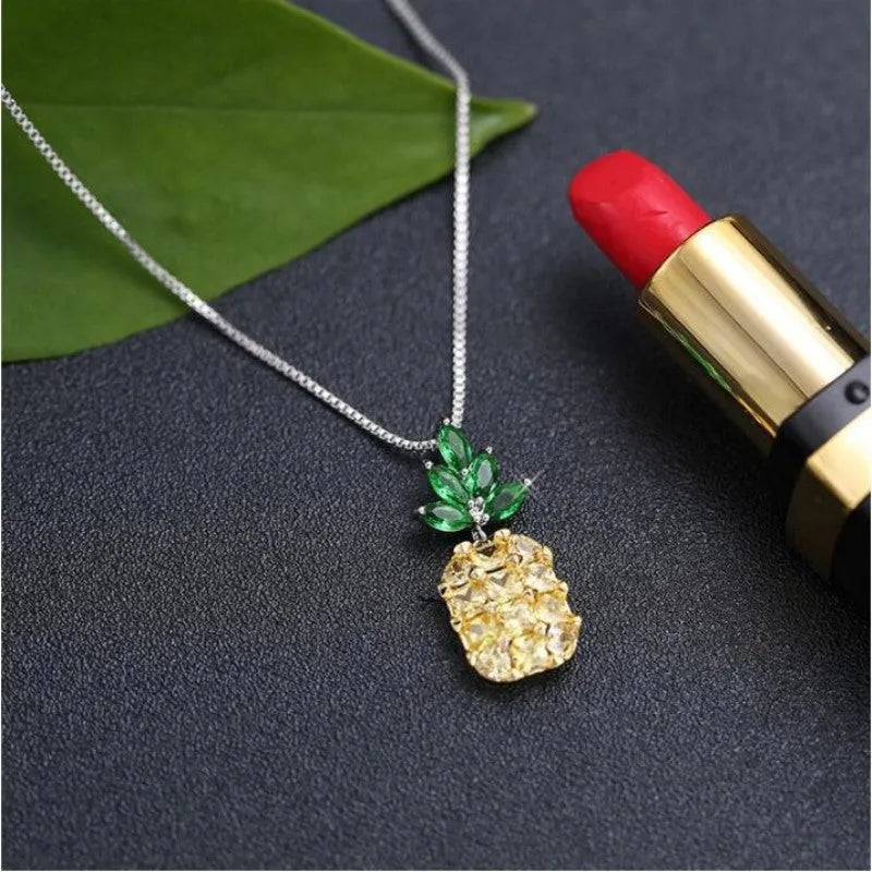 Silver geometric pineapple necklace with diamond-style stones on model
