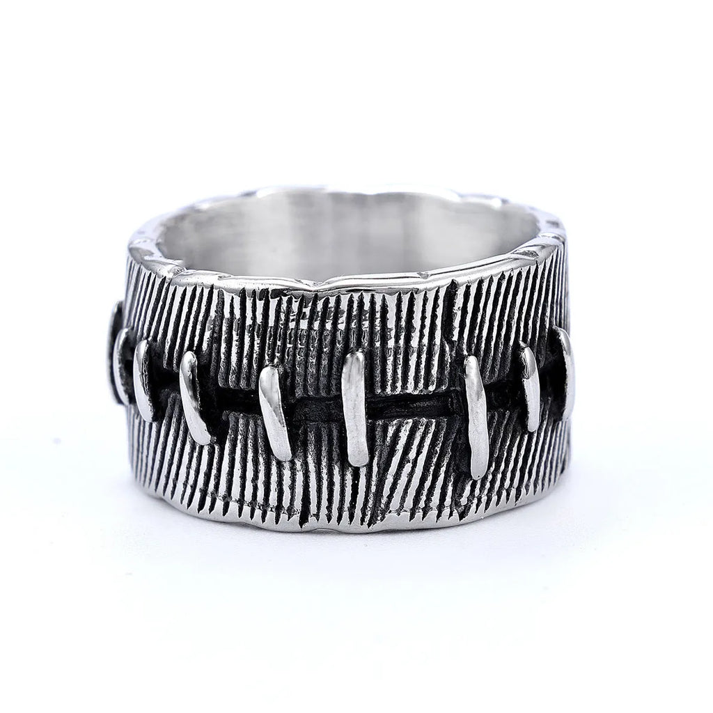 Geometric dark punk double ring in titanium steel on a black background, showing its U-shaped silhouette.