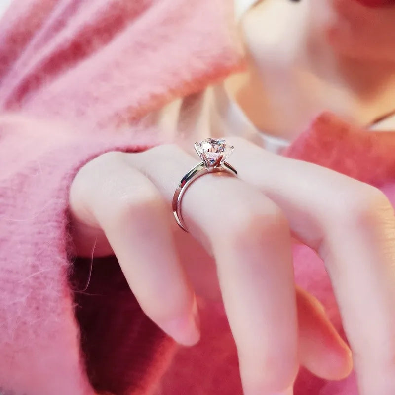 Six-claw set zircon ring with geometric design and white gold plated finish on white copper