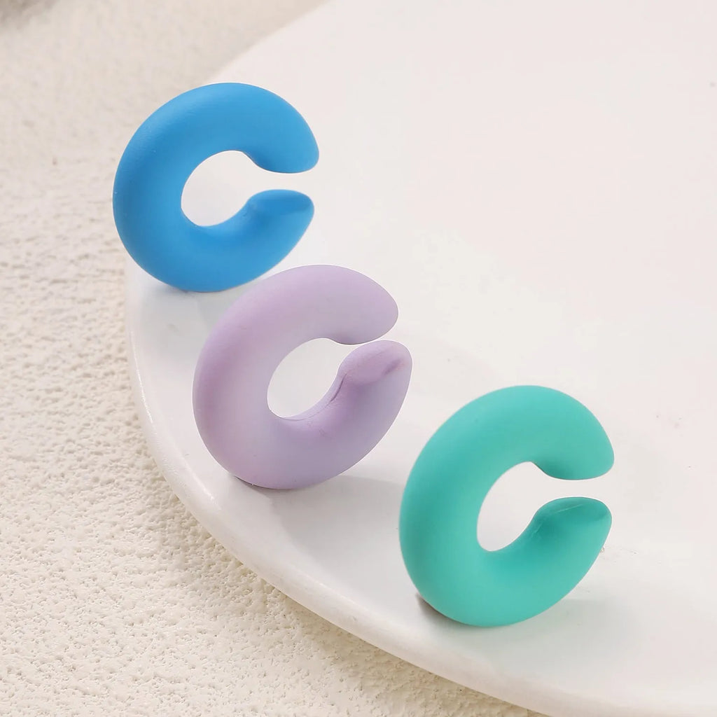 C-shaped geometric clip-on earrings with matte coarse finish in a selection of candy colours