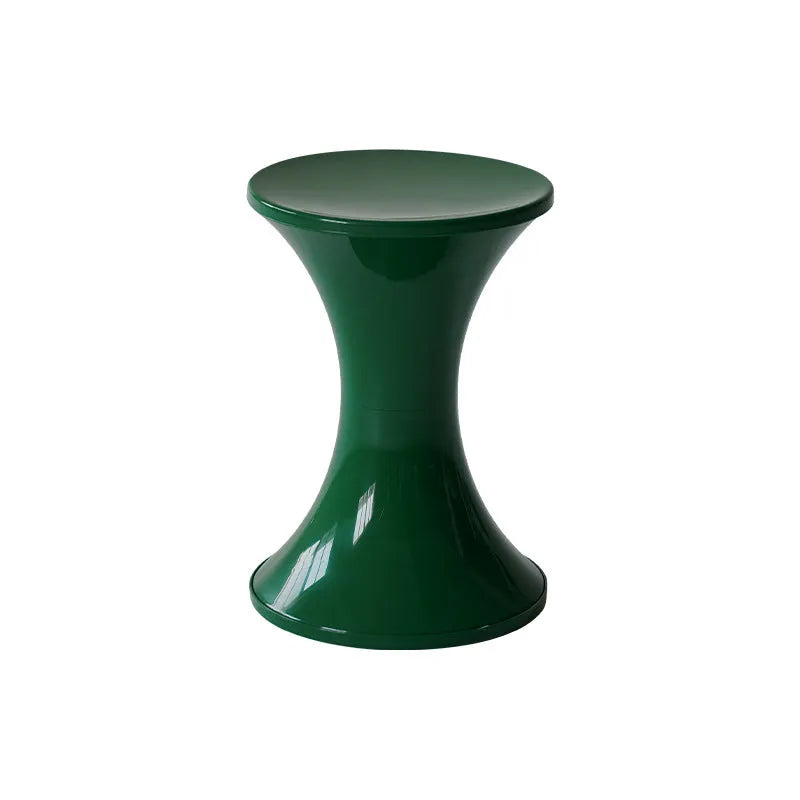 Plastic hourglass-style shoe changing stool in green, shown in a home entryway.