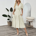 Light green twill shirt dress with lapel, fitted waist and commuter pockets