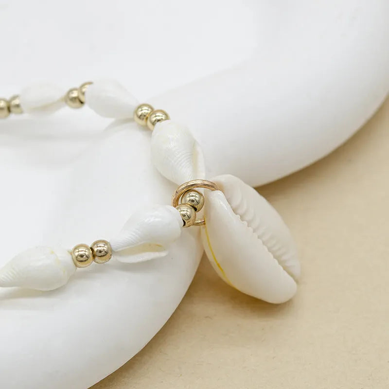 White conch shell necklace for women with a natural mother of pearl pendant on a chain.