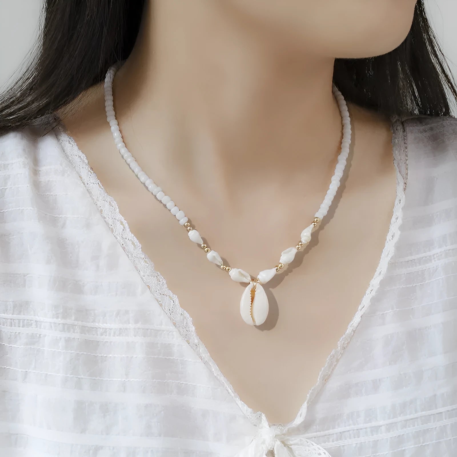 White conch shell necklace for women with a natural mother of pearl pendant on a chain.
