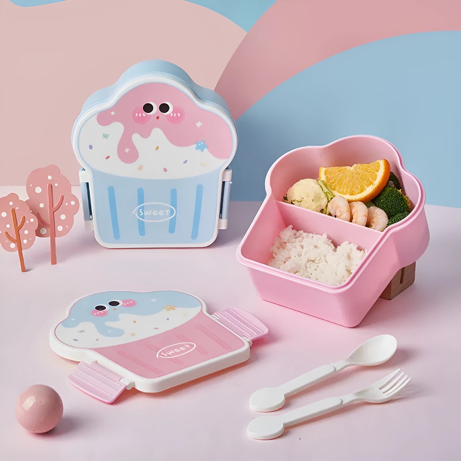 Pink and blue creative ice cream shaped plastic lunch box with spoon and fork on a white background.