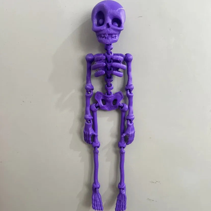 3D printed Halloween skull ornament in multiple colours displayed as fridge magnet