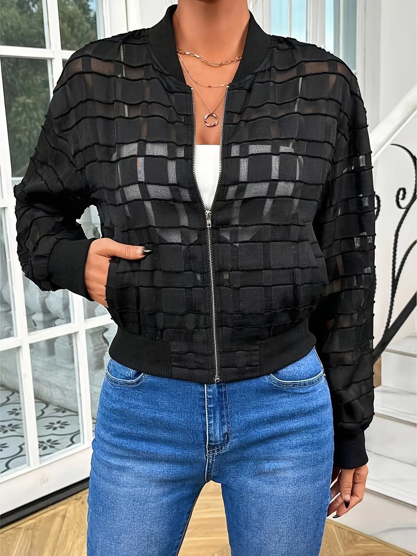 Black women's casual zip jacket with a geometric pattern on semi-transparent polyester fabric.