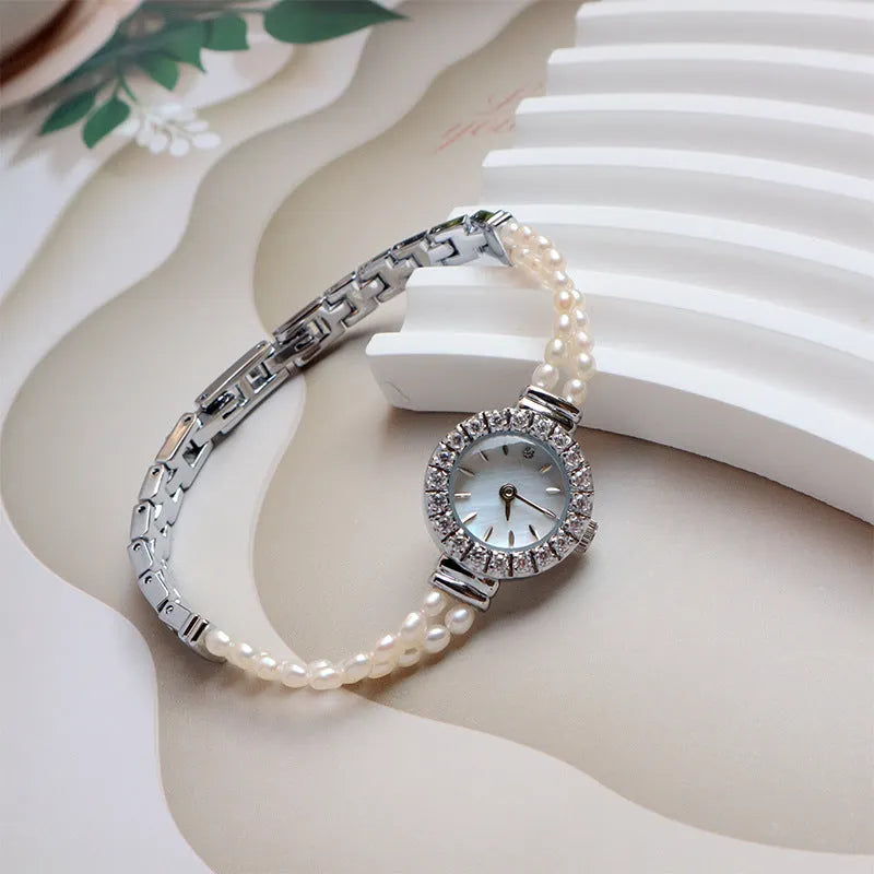 Women's light gold freshwater pearl bracelet watch with round dial on stainless steel strap