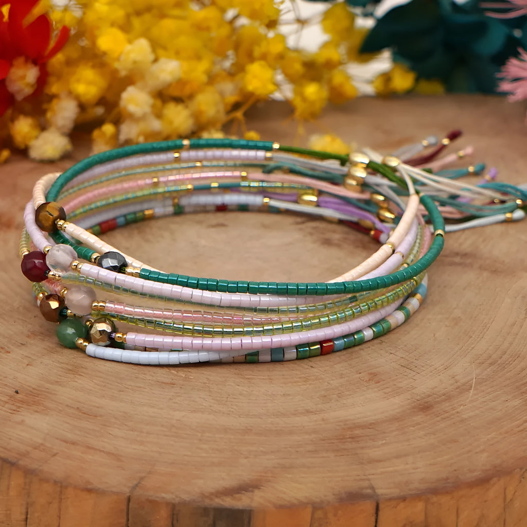 Close-up of a colourful handmade Bohemian bracelet with semi-precious stone and glass geometry beads on a wrist.