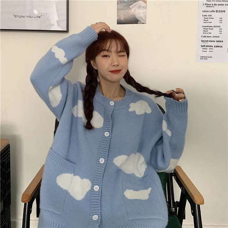 Blue women's loose cardigan with white cloud pattern, long sleeves, shown on a hanger.