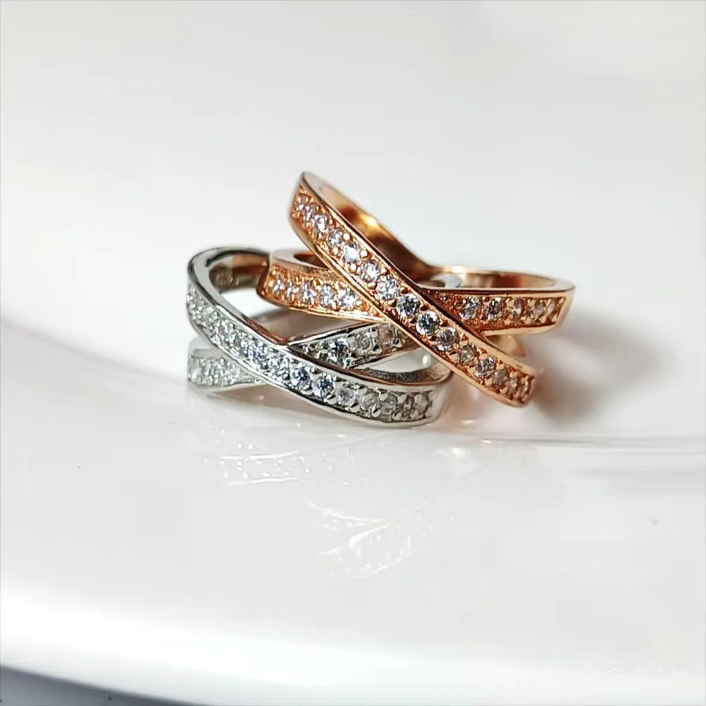 Geometric heart-shaped cross ring with micro-inlaid zircon details on a copper band.