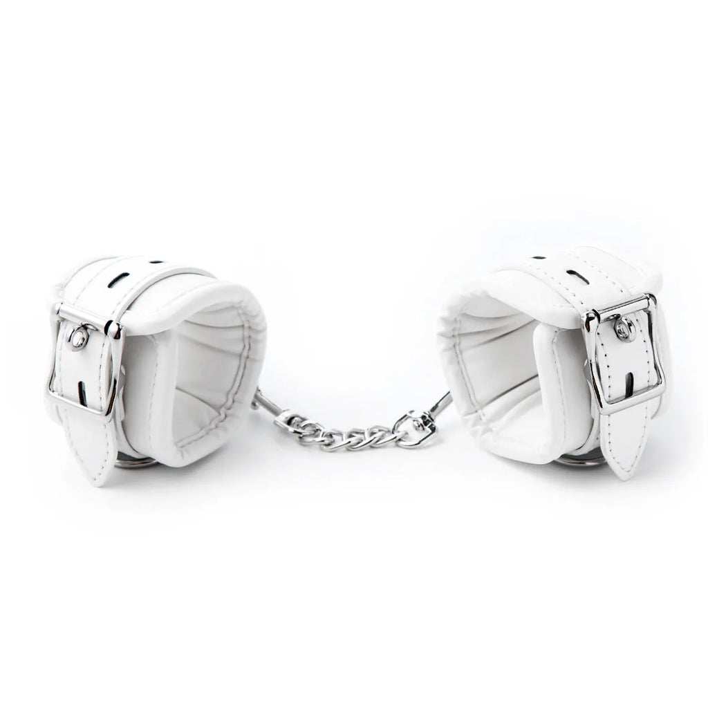 White PU sponge bondage kit showing handcuffs, foot cuffs, and a neck cuff for adult restraint play.