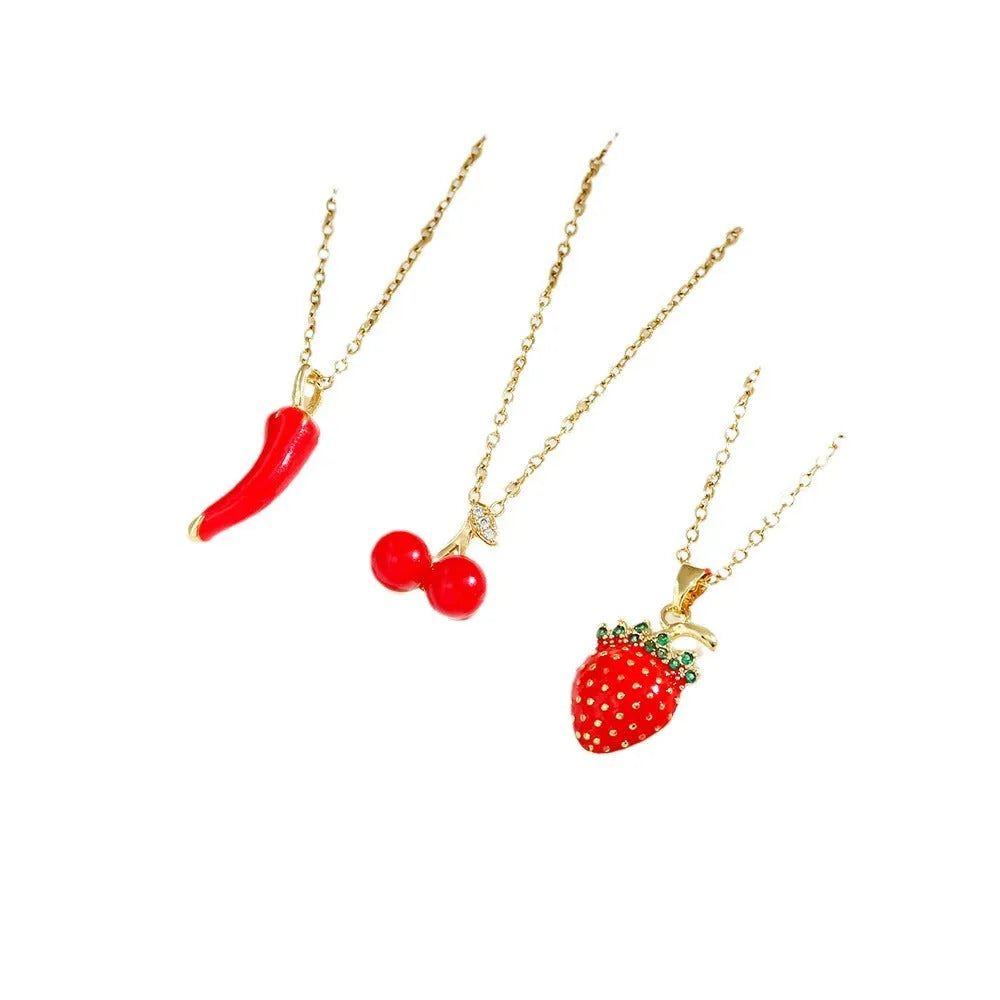 Delicate titanium steel necklace with a small cherry charm on an O-ring chain, gold finish.