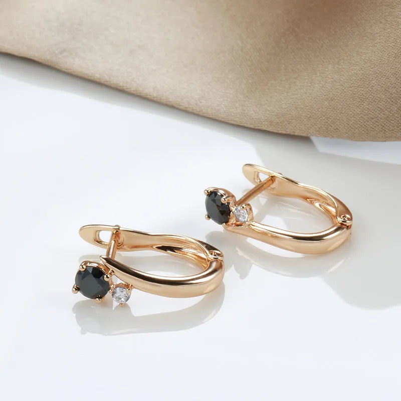 Women's gold drop earrings with black agate geometric design and clip-on back