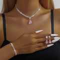 Claw chain necklace and matching earrings set with drop-shaped rhinestones in blue colour