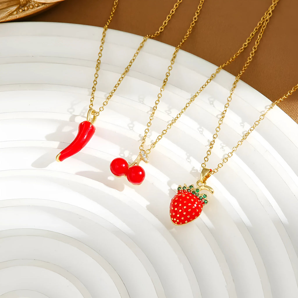 Delicate titanium steel necklace with a small cherry charm on an O-ring chain, gold finish.