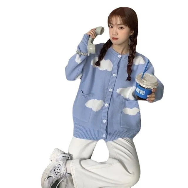 Blue women's loose cardigan with white cloud pattern, long sleeves, shown on a hanger.