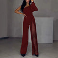 Black women's long sleeve jumpsuit with a high slit on the leg, made from thin polyester fabric.