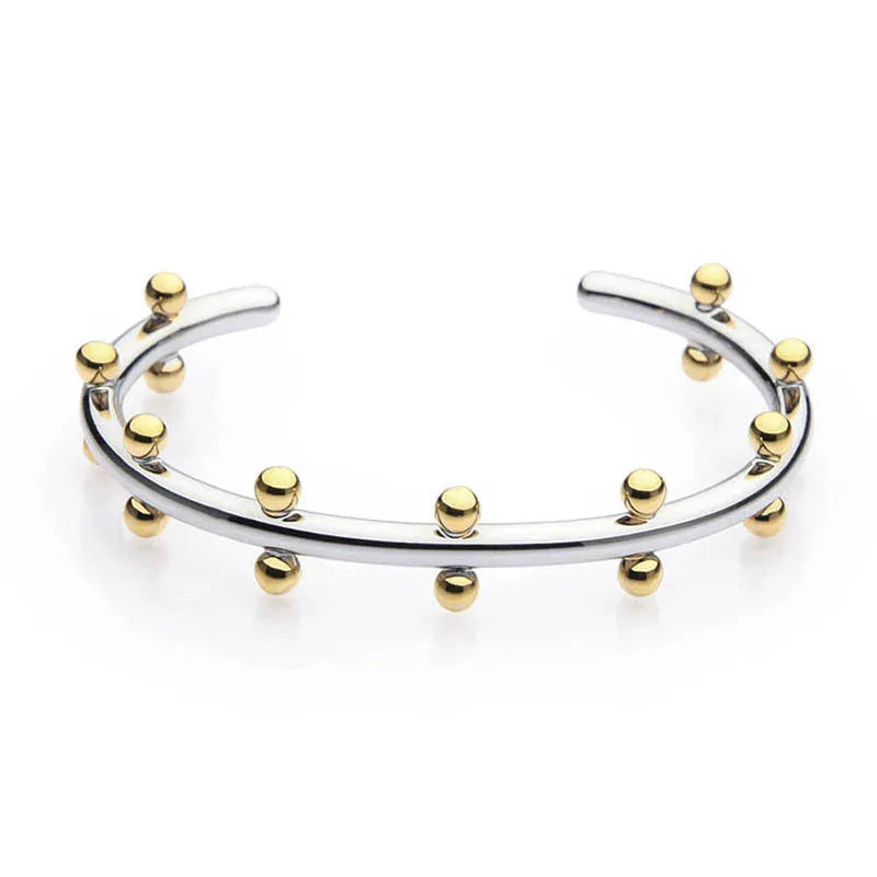 Stainless steel C-shaped charm with textured rivet bean beads on a round alloy bracelet.
