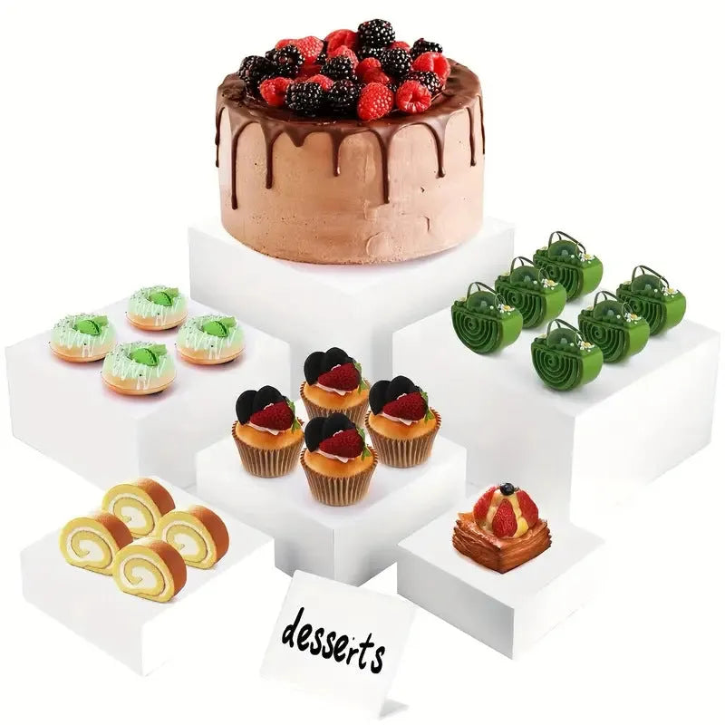 White plastic modular cube dessert display stand with six stackable units for cakes and pastries