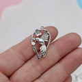 Close-up of an alloy pendant charm featuring a detailed magpie or cuckoo bird design with an electroplated finish.