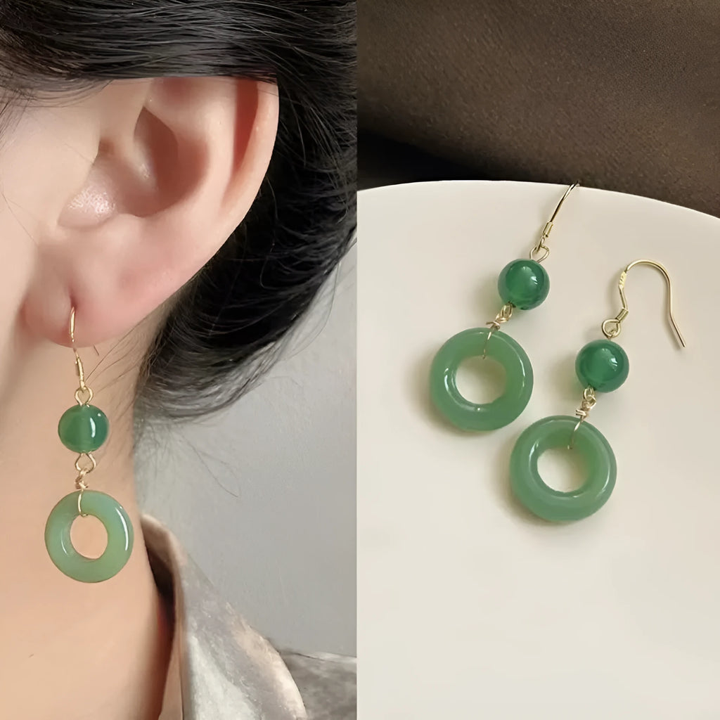 Pair of green jade design earrings with a geometric peace buckle shape on a zinc alloy base with gold plating.