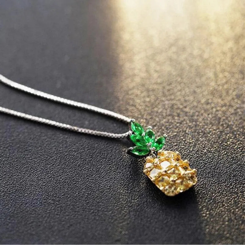 Silver geometric pineapple necklace with diamond-style stones on model