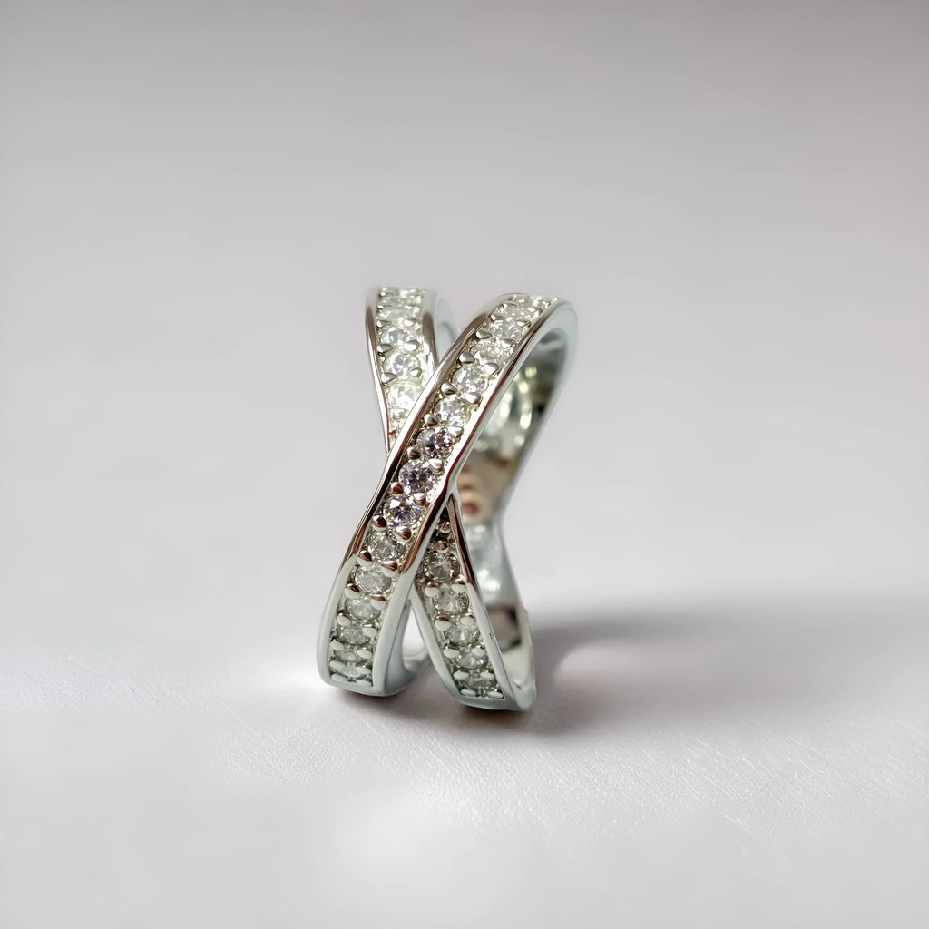 Geometric heart-shaped cross ring with micro-inlaid zircon details on a copper band.