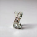 Geometric heart-shaped cross ring with micro-inlaid zircon details on a copper band.