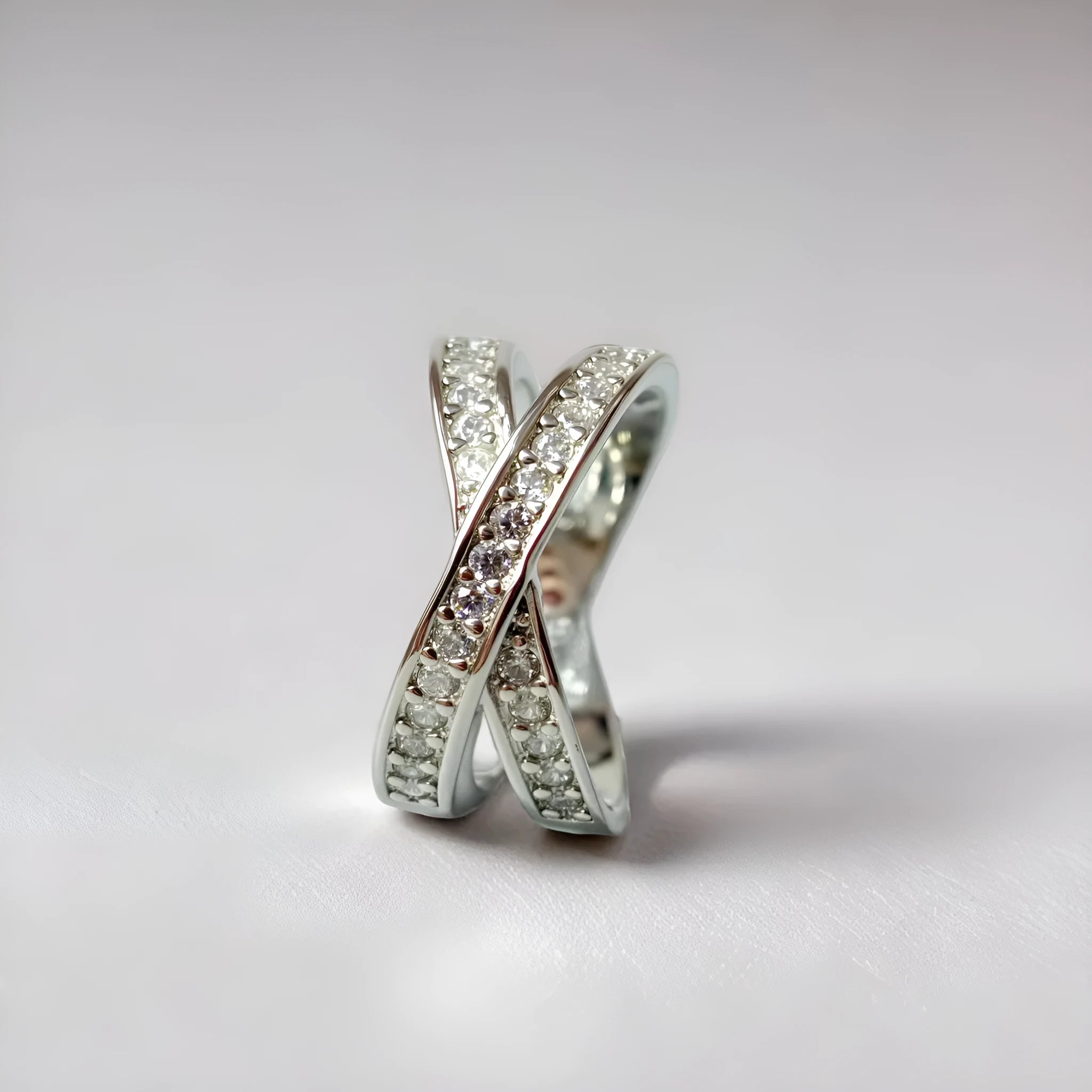 Geometric heart-shaped cross ring with micro-inlaid zircon details on a copper band.